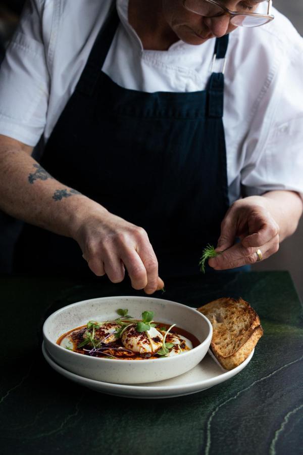Ebb-Dunedin Esterno foto A chef preparing a dish